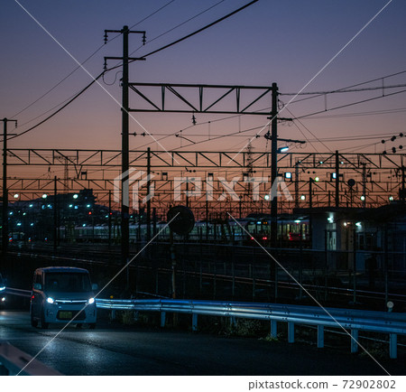Overhead line against the backdrop of the madder-colored sunset Overhead line against the backdrop of the madder-colored sunset 72902802