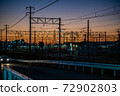 Overhead line against the backdrop of the madder-colored sunset 72902803