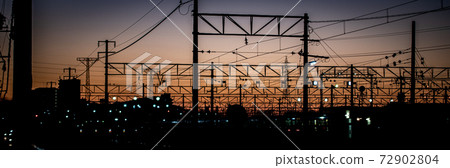 Overhead line against the backdrop of the madder-colored sunset Overhead line against the backdrop of the madder-colored sunset 72902804