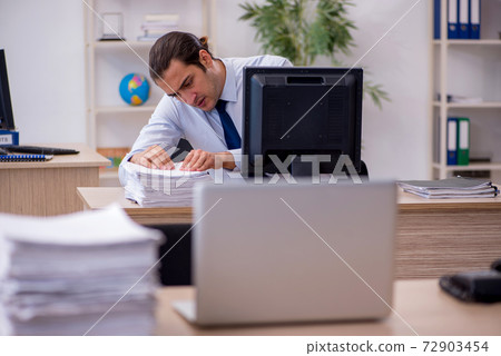 Young male employee sitting in the office 72903454