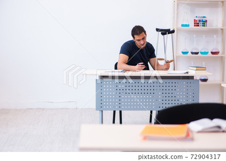 Young male student after accident preparing for exams 72904317