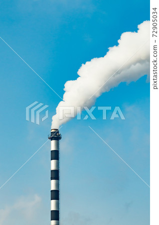 Chimney smoke at factory against blue sky Chimney smoke at factory against blue sky 72905034