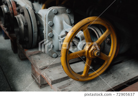 A large shut-off valve lies on a pallet in the warehouse. Storage of gasification equipment. A large shut-off valve lies on a pallet in the warehouse. Storage of gasification equipment. 72905637
