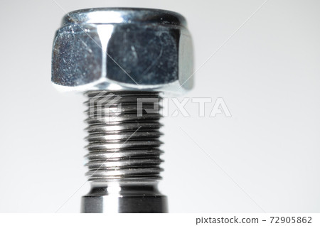 Close-up of the thread and nut on the studs of the ball joint of the front auto suspension Close-up of the thread and nut on the studs of the ball joint of the front auto suspension 72905862