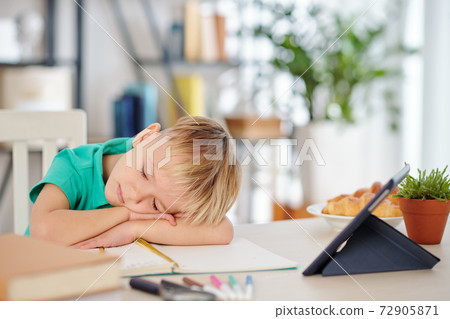 Schoolboy sleeping on his table Schoolboy sleeping on his table 72905871