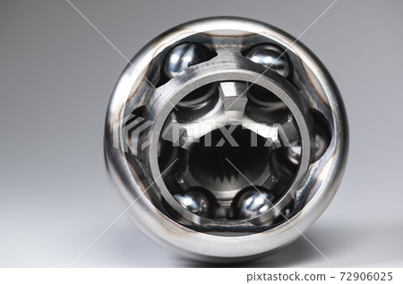 Close-up of a new CV joint on a gray background. Car suspension parts Close-up of a new CV joint on a gray background. Car suspension parts 72906025