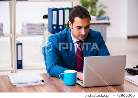 Young male employee working in the office 72906300