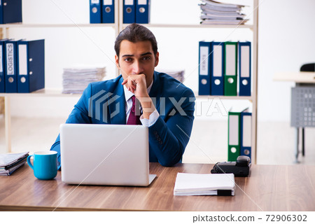 Young male employee working in the office 72906302