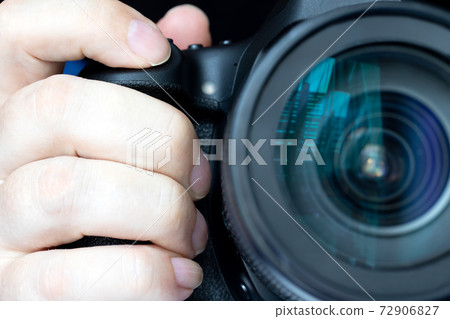 A pressing the shot button of a camera, close up. A take a picture. 72906827