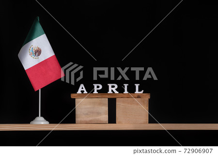 Wooden calendar of April with Mexico flag on black background. Holidays of Mexico in April 72906907