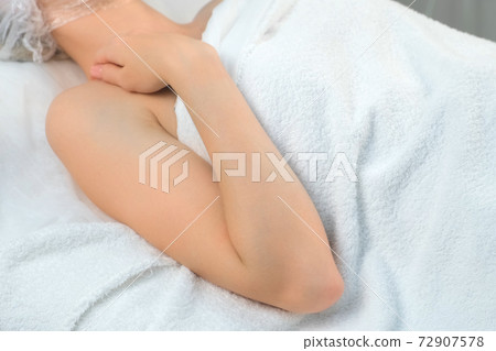 Woman in hospital with bended arm after giving blood sampling, hand closeup. 72907578