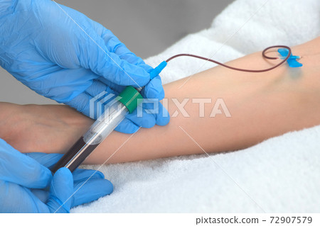Laboratory worker doctor takes a blood sample for analysis, hand closeup. 72907579
