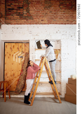 New property owners, young couple moving to new home, apartment, look happy 72907692