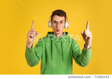Portrait of young caucasian man isolated on yellow studio background Portrait of young caucasian man isolated on yellow studio background 72908145