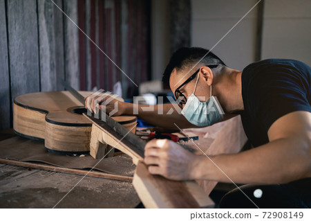 craft man making guitar on wood table, capenter working concept craft man making guitar on wood table, capenter working concept 72908149