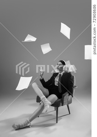 Young fashionable, stylish woman wearing jacket and socks working from home. Fashion during insulation 'cause of coronavirus pandemic 72908686