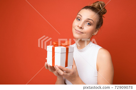 Beautiful happy young blonde woman isolated over colourful background wall wearing stylish casual Beautiful happy young blonde woman isolated over colourful background wall wearing stylish casual 72909078