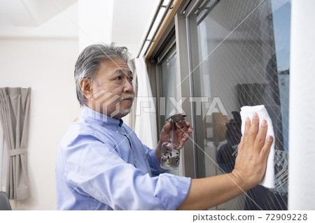 Seniors cleaning the living room Seniors cleaning the living room 72909228