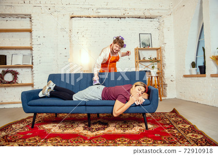 Gender stereotypes. Wife and husband doing things unusual for their genders in social meanings Gender stereotypes. Wife and husband doing things unusual for their genders in social meanings 72910918