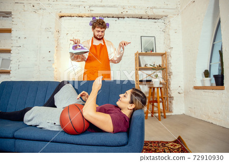 Gender stereotypes. Wife and husband doing things unusual for their genders in social meanings Gender stereotypes. Wife and husband doing things unusual for their genders in social meanings 72910930