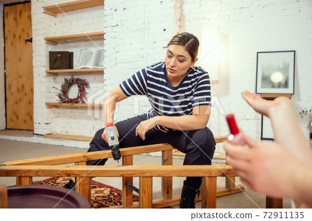 Gender stereotypes. Wife and husband doing things unusual for their genders in social meanings 72911135
