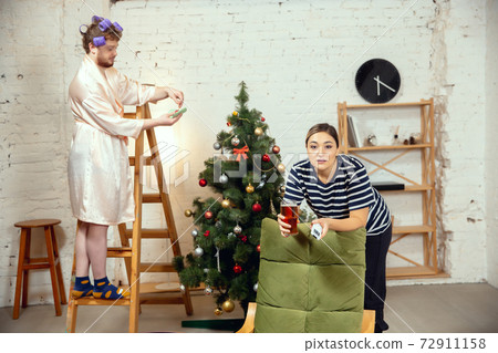 Gender stereotypes. Wife and husband doing things unusual for their genders in social meanings Gender stereotypes. Wife and husband doing things unusual for their genders in social meanings 72911158