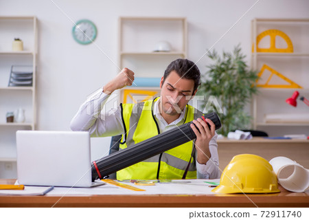 Young male architect working in the office 72911740