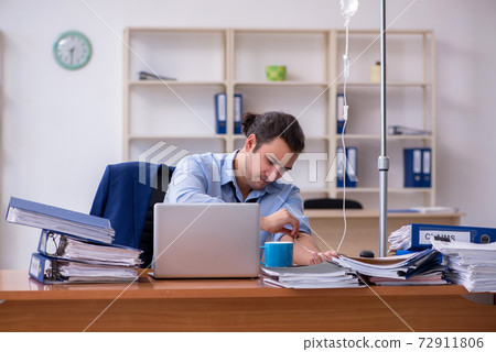 Young male employee suffering at workplace Young male employee suffering at workplace 72911806