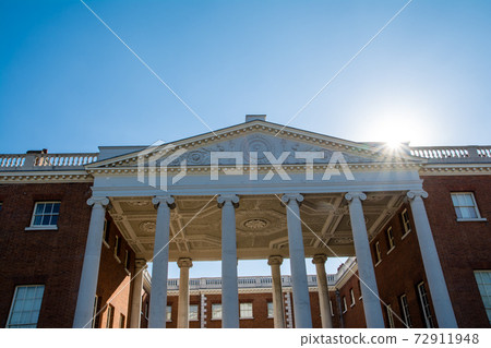 A large historic red brick building in the bright sun under a clear sky at Osterley Park on the outskirts of London A large historic red brick building in the bright sun under a clear sky at Osterley Park on the outskirts of London 72911948