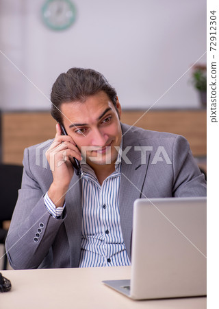 Young male employee working in the office Young male employee working in the office 72912304