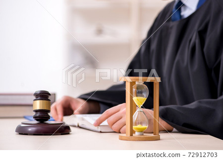 Young male judge in time management concept 72912703
