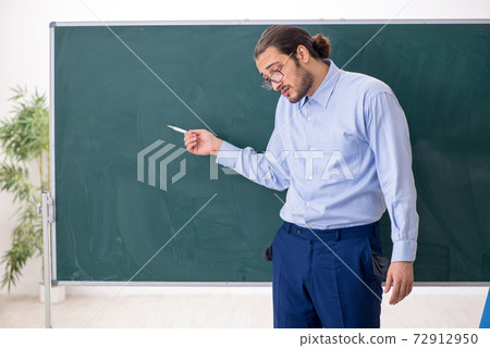 Young underpaid male teacher in the classroom Young underpaid male teacher in the classroom 72912950
