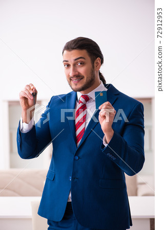 Handsome male realtor working indoors 72912953