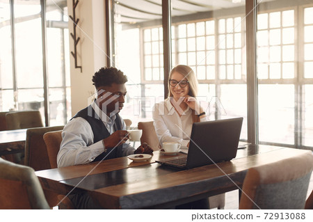 Stylish people working in a office and use the laptop 72913088