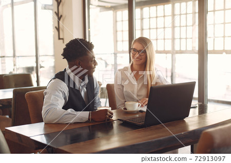 Stylish people working in a office and use the laptop Stylish people working in a office and use the laptop 72913097