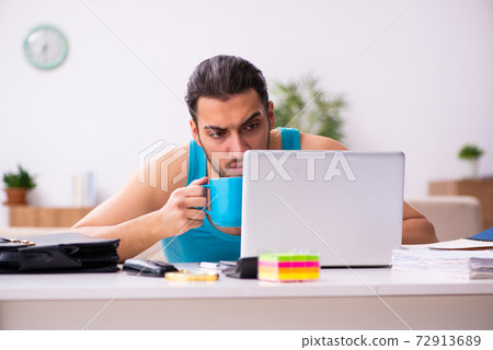 Young man working from house during pandemic Young man working from house during pandemic 72913689