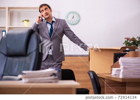 Young male employee being dismissed from his work Young male employee being dismissed from his work 72914134