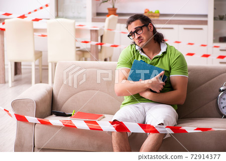 Young male student studying at home in self-isolation concept 72914377