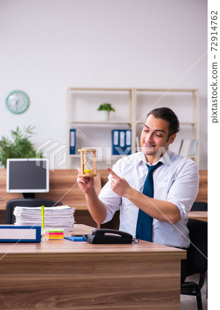 Young male employee working in the office Young male employee working in the office 72914762