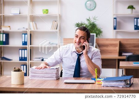 Young male employee working in the office Young male employee working in the office 72914770