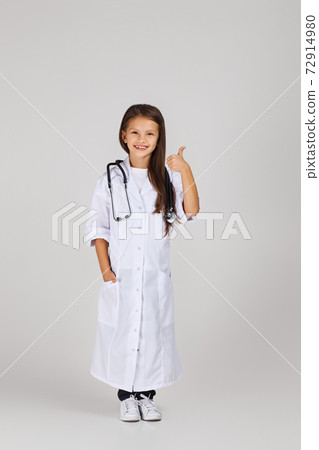 Cute child in doctor coat with stethoscope Cute child in doctor coat with stethoscope 72914980