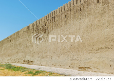 Ancient medieval big protective reinforcement wall with adobe clay material. 72915267