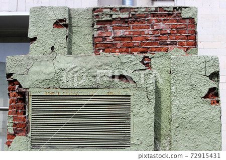 peeling green plaster on a brick transformer box. background for the image of devastation and mismanagement. Russia peeling green plaster on a brick transformer box. background for the image of devastation and mismanagement. Russia 72915431