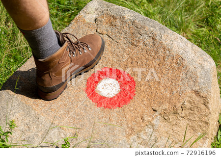 Hiking boot and a hiking trail mark 72916196