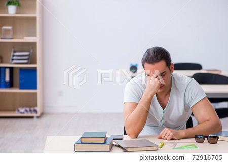 Young male student preparing for exam in the classroom 72916705