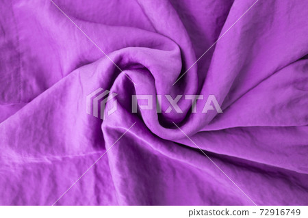 Luxurious expensive blue fabric as an elegant background with beautiful tints of light. Soft folds fall and create light waves Luxurious expensive blue fabric as an elegant background with beautiful tints of light. Soft folds fall and create light waves 72916749