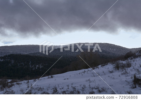 Snowy mountain landscape 72916808