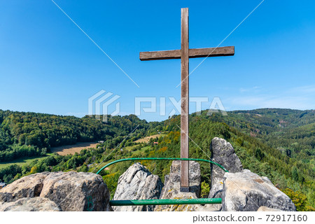 Wooden cross on the top rock Wooden cross on the top rock 72917160
