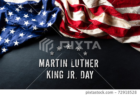 Martin Luther King Day anniversary concept. American flag against black wooden background Martin Luther King Day anniversary concept. American flag against black wooden background 72918528