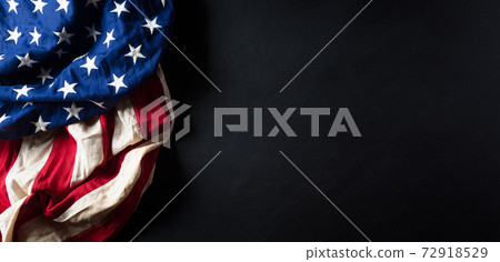 Martin Luther King Day anniversary concept. American flag against black wooden background Martin Luther King Day anniversary concept. American flag against black wooden background 72918529